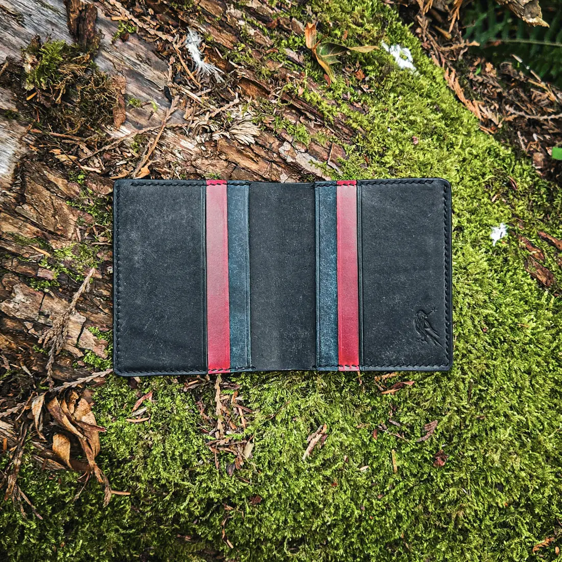 Handcrafted leather goods photographed on moss