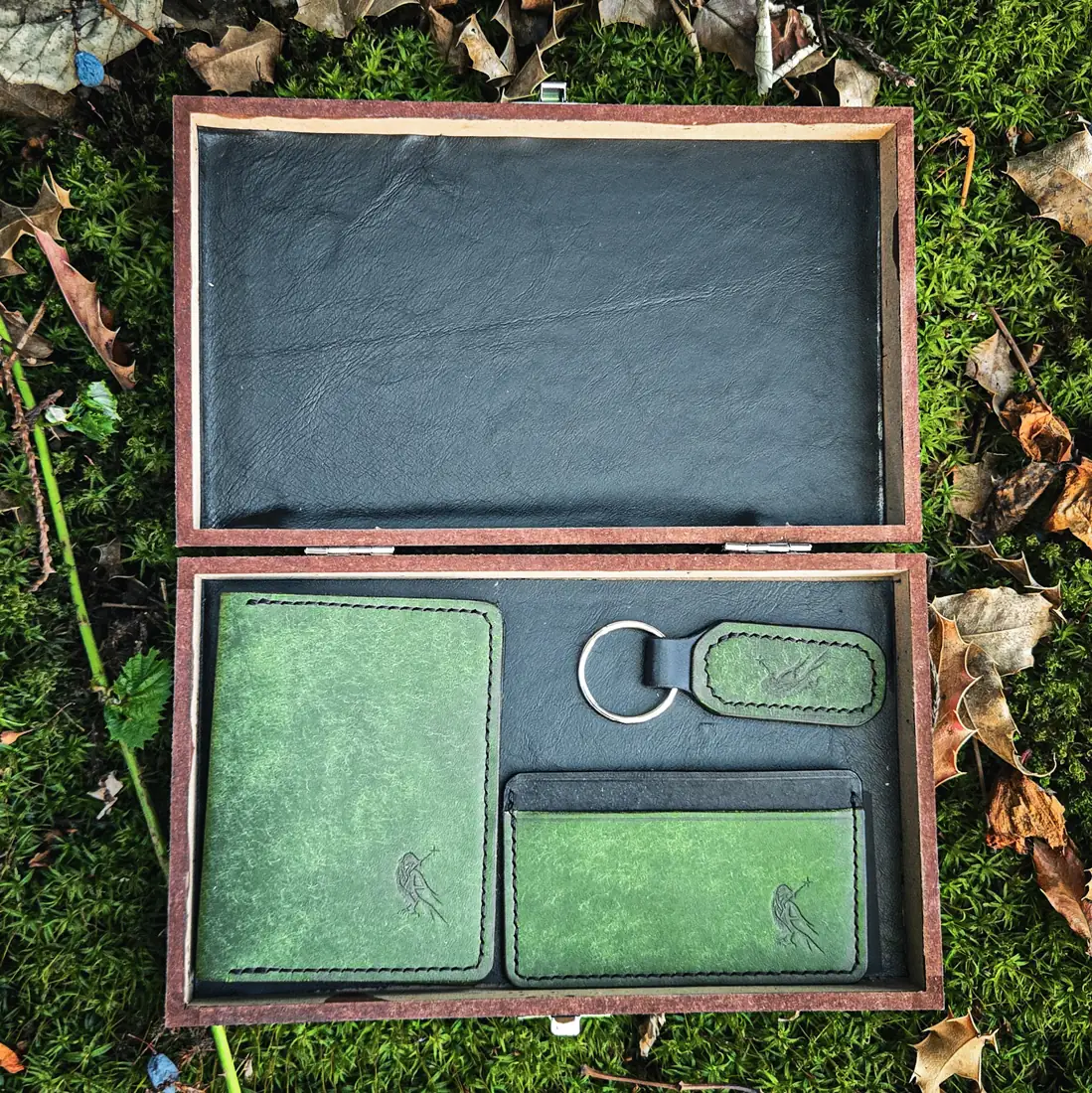 Handcrafted leather goods photographed on moss