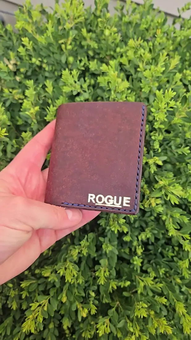 Handcrafted leather goods photographed on moss
