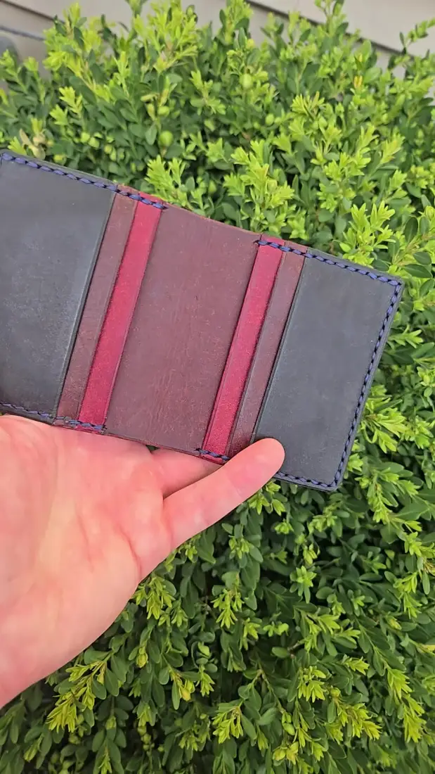 Handcrafted leather goods photographed on moss